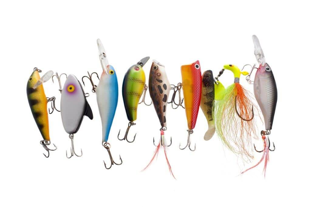 Close up image of different and colorful fishing lures against white background