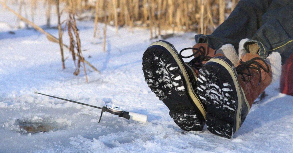 Person wearing boots while ice fishing