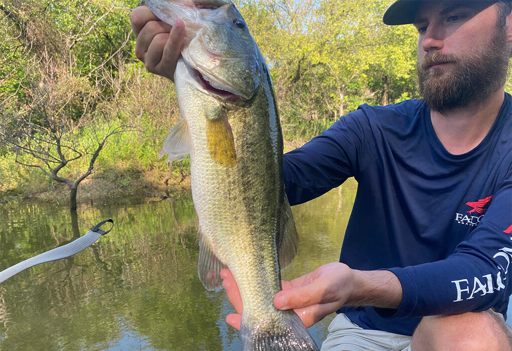 angler and his catch, a bass fish