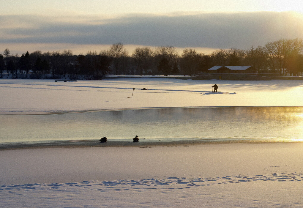 ice fishing on a frozen lake