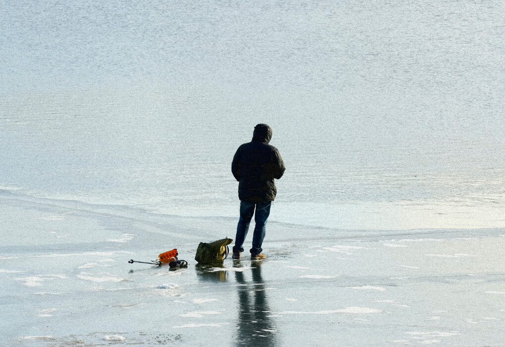 fishermen standing on ice