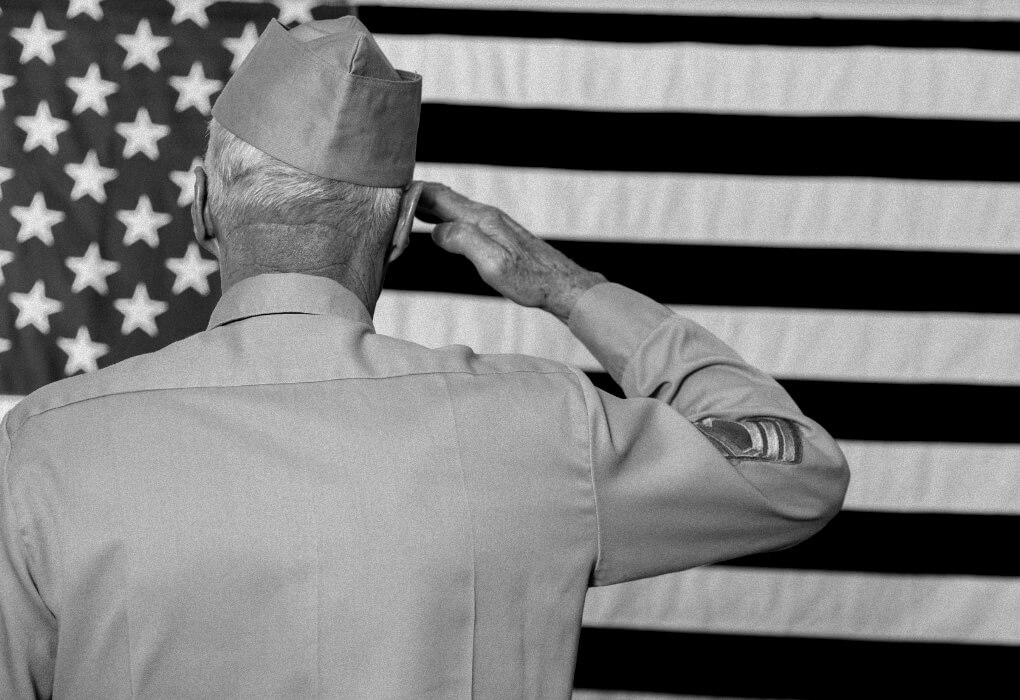 military veteran salutes the US flag