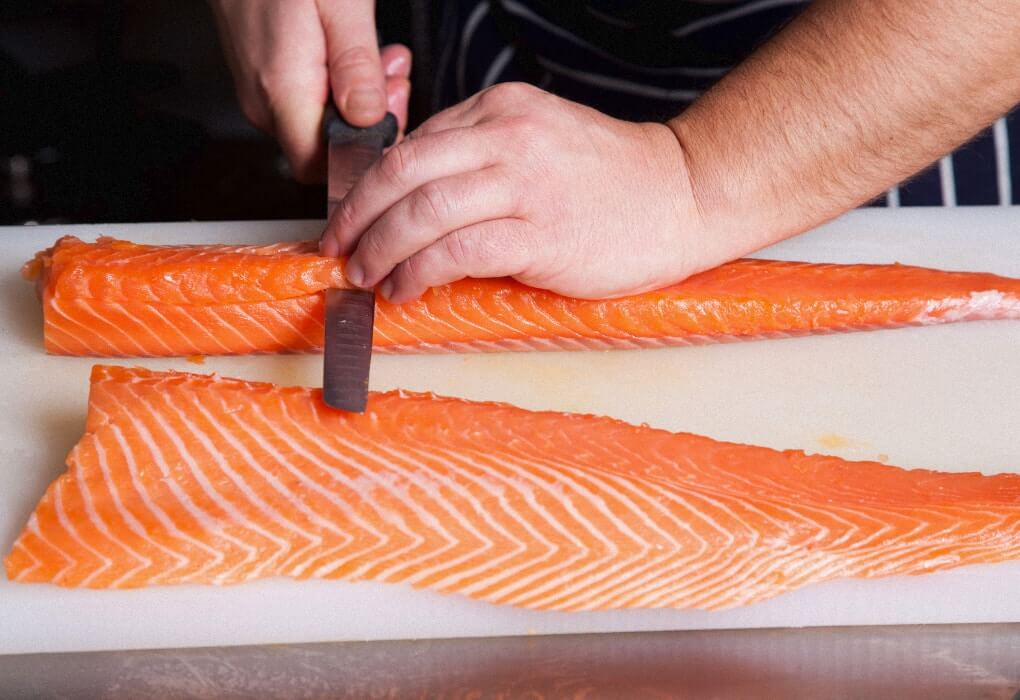 filleting a salmon with the best fishing fillet knife