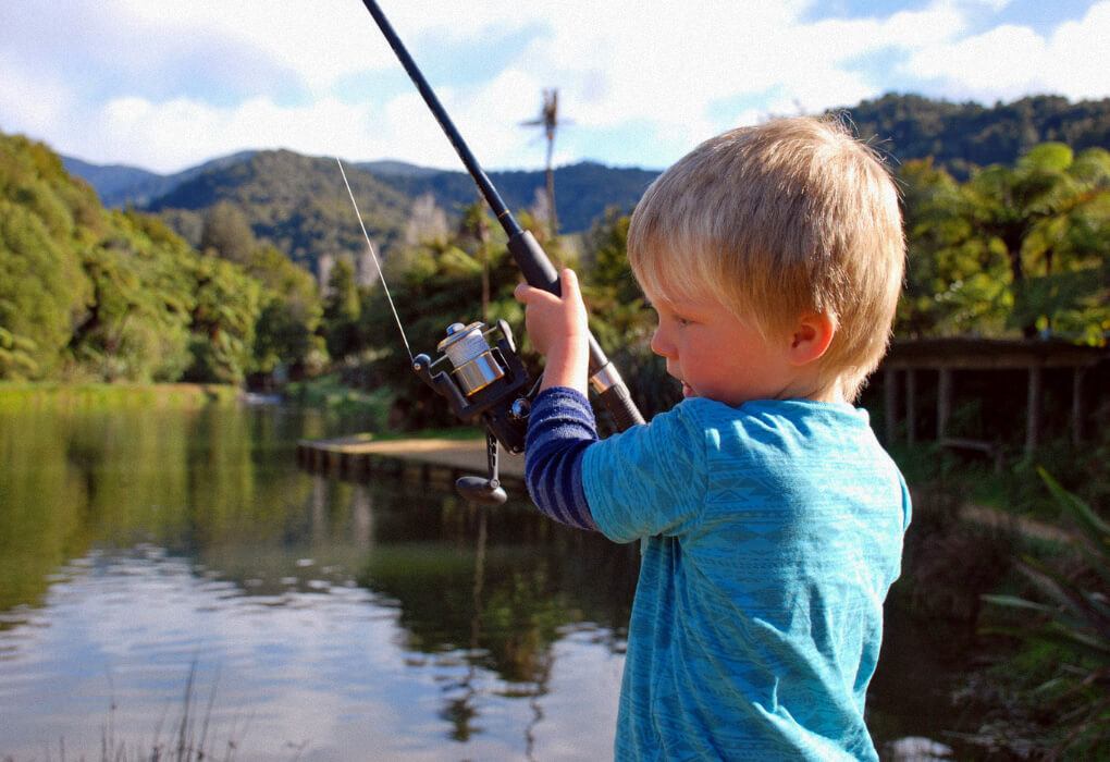 child fishing on a lake