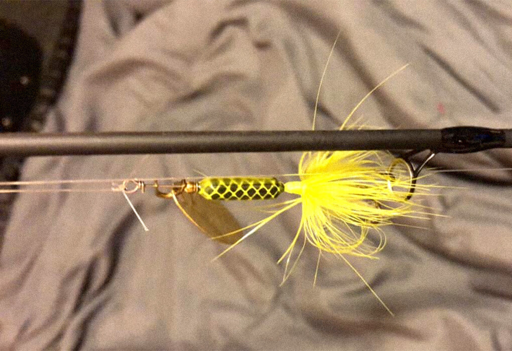 rooster tail fishing lure rigged on a fishing pole
