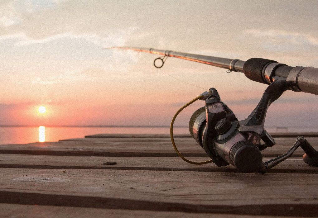 fishing rod and reel combo on a pier