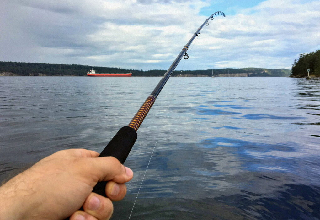 man holding a jigging rod