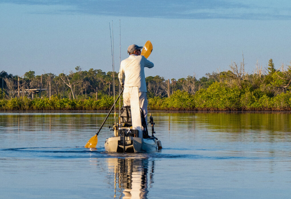 man fishing while standing from a stand up fishing kayak