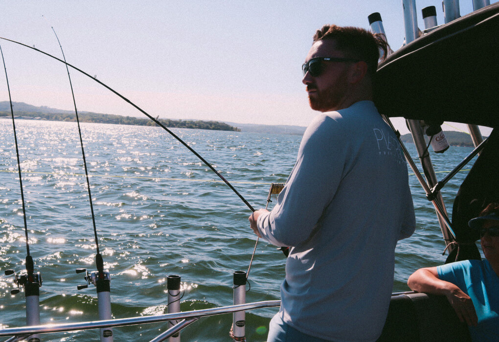 fisherman out on water fishing, having his fishing sunglasses on