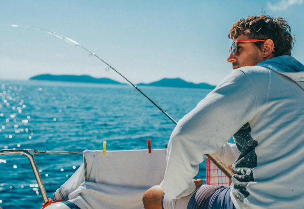 fisherman out on water fishing, having his fishing sunglasses on